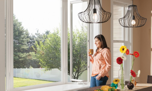 woman drinking coffee by an open window